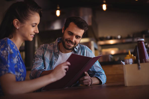 couple looking at menu in bar