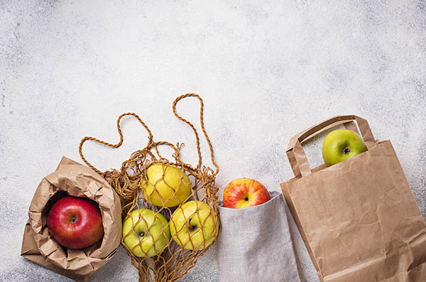 apples in different eco-friendly packaging, top view