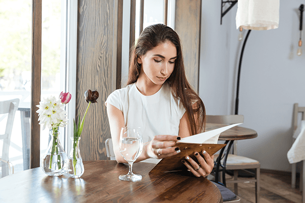How to Inflation Proof your Menu. Woman reading menu
