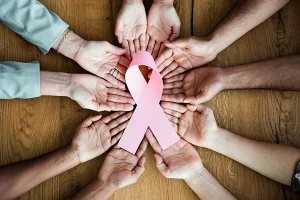 Hands holding breast cancer awareness ribbon - nutrition's role in cancer prevention - featured image