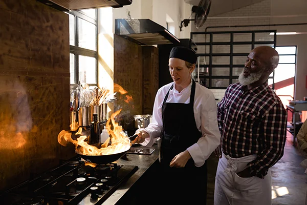 chefs cooking with fire