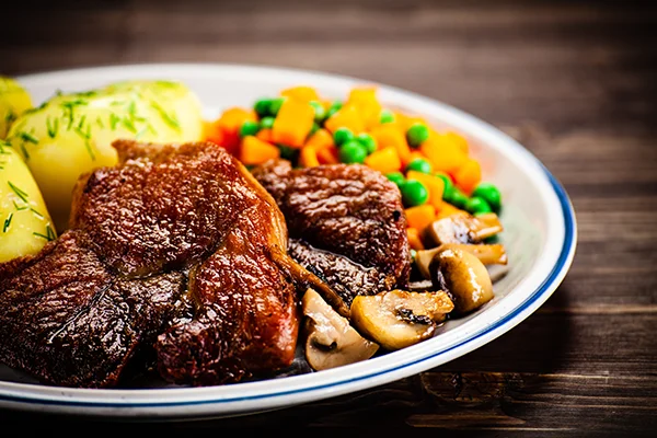 grilled steak with potatoes and vegetable salad