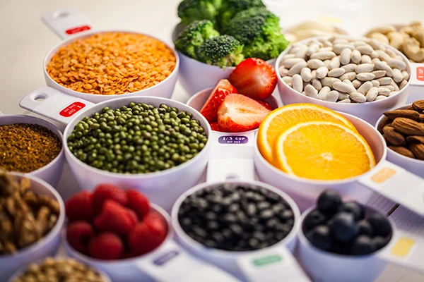 portion cups of healthy ingredients on wooden table