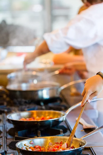 Professional chefs preparing food in a restaurant kitchen